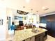 Bright, open-concept kitchen and living area with an island, breakfast bar, and modern lighting fixtures above the countertops at 3414 Sandpiper Dr, Punta Gorda, FL 33950
