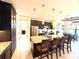 Modern kitchen with an island, dark cabinets, granite countertops and bar stool seating for easy entertaining at 3414 Sandpiper Dr, Punta Gorda, FL 33950
