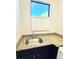 Laundry room with a stainless sink, granite countertops, dark cabinets, and window at 3414 Sandpiper Dr, Punta Gorda, FL 33950