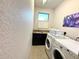 Laundry room including granite countertops, stainless sink, front load washer and dryer at 3414 Sandpiper Dr, Punta Gorda, FL 33950