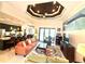 Open-concept living room featuring a decorative ceiling, poolside access, and seamless transition into the modern kitchen at 3414 Sandpiper Dr, Punta Gorda, FL 33950
