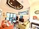 The living room is furnished with comfortable seating and features a tray ceiling and view of the screened-in pool area at 3414 Sandpiper Dr, Punta Gorda, FL 33950