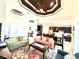 Spacious living room featuring stylish furnishings, decorative ceiling, and seamless flow into the adjacent kitchen and dining area at 3414 Sandpiper Dr, Punta Gorda, FL 33950