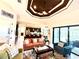 Open-concept living room featuring access to the poolside, decorative ceiling, and seamless view into the modern kitchen at 3414 Sandpiper Dr, Punta Gorda, FL 33950