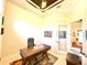Home office featuring a tray ceiling, a work desk, and an open doorway, providing a versatile workspace at 3414 Sandpiper Dr, Punta Gorda, FL 33950