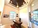 Cozy office with natural light, tray ceiling, and vibrant artwork, perfect for a productive work environment at 3414 Sandpiper Dr, Punta Gorda, FL 33950