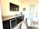 Outdoor bar area with countertop, mini-fridge, and mounted TV; ideal for relaxing and entertaining guests at 3414 Sandpiper Dr, Punta Gorda, FL 33950
