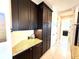 Pantry with dark brown cabinets and granite countertops with a view of another room at 3414 Sandpiper Dr, Punta Gorda, FL 33950
