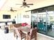 Covered outdoor patio space with ceiling fans, dining table, and sliding glass doors at 3414 Sandpiper Dr, Punta Gorda, FL 33950