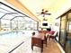 Inviting covered patio featuring a dining area, outdoor living space, and a screened-in pool, perfect for entertaining at 3414 Sandpiper Dr, Punta Gorda, FL 33950