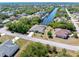 A sprawling lawn and established trees frame a home located right on a canal at 4053 Joseph St, Port Charlotte, FL 33948