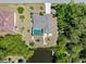 A bird's eye view depicts a home near a canal, lush greenery, and mature landscaping at 4053 Joseph St, Port Charlotte, FL 33948