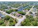 An aerial view shows a property situated on a canal with mature trees nearby at 4053 Joseph St, Port Charlotte, FL 33948