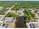Mature landscaping frames a property with a pool and backyard canal access at 4053 Joseph St, Port Charlotte, FL 33948