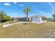 Expansive backyard featuring lush greenery, a charming palm tree, and a sparkling pool at 4053 Joseph St, Port Charlotte, FL 33948