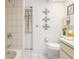 Bright bathroom featuring white tile, decorative wall art, and a shower/bath combo at 4053 Joseph St, Port Charlotte, FL 33948