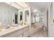 Large bathroom featuring dual sinks, a separate tub, and ample counter space at 4053 Joseph St, Port Charlotte, FL 33948