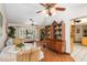 Open-concept dining area with hardwood floors, vintage china cabinet and stylish furnishings at 4053 Joseph St, Port Charlotte, FL 33948