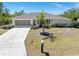 This is a single Gathering home with an attached garage, a pristine lawn, and mature landscaping at 4053 Joseph St, Port Charlotte, FL 33948