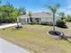 A well manicured lawn and tropical landscaping highlight this bright and airy single Gathering home at 4053 Joseph St, Port Charlotte, FL 33948