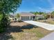 Charming home boasts a well-manicured lawn, mature landscaping, and a spacious driveway at 4053 Joseph St, Port Charlotte, FL 33948