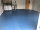 Spacious garage with epoxy flooring, laundry hookups, water heater, and additional storage space at 4053 Joseph St, Port Charlotte, FL 33948