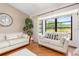 Bright living room with hardwood floors, a large bay window, and comfortable seating at 4053 Joseph St, Port Charlotte, FL 33948