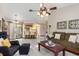 Open-concept living room with tile floors, modern furniture, and adjacent kitchen at 4053 Joseph St, Port Charlotte, FL 33948