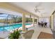 Covered lanai with ceiling fans, outdoor dining, and views of the beautiful canal and pool at 4053 Joseph St, Port Charlotte, FL 33948