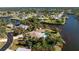 Captivating aerial showcases the property's canal-front setting, pool, and the lush surrounding neighborhood at 4438 Meager Cir, Port Charlotte, FL 33948