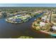 Enchanting aerial shot highlights a home situated on a waterfront point, complete with private dock at 4438 Meager Cir, Port Charlotte, FL 33948