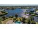 High-angle view featuring a backyard pool and canal frontage, highlighting a blend of relaxation and nature at 4438 Meager Cir, Port Charlotte, FL 33948