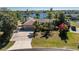 Waterfront property with a lush lawn and gardens leading to tranquil canal views and a large private driveway at 4438 Meager Cir, Port Charlotte, FL 33948