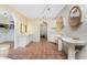 Bathroom showcasing dual vanities, makeup lighting, and terra cotta tile flooring at 4438 Meager Cir, Port Charlotte, FL 33948