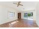 Bedroom featuring tile floors, a ceiling fan, and access to the outdoor pool area at 4438 Meager Cir, Port Charlotte, FL 33948