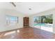 Bedroom boasting tile floors and views of the outdoor pool and natural light at 4438 Meager Cir, Port Charlotte, FL 33948