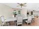 Dining area with a large table, offering seamless access to the outdoors through sliding glass doors at 4438 Meager Cir, Port Charlotte, FL 33948