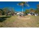 Exterior view of a home with lush landscaping and lawn on a sunny day at 4438 Meager Cir, Port Charlotte, FL 33948