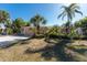 Charming single-story home featuring a well-manicured lawn, mature landscaping, and a private gated entrance at 4438 Meager Cir, Port Charlotte, FL 33948