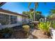 Charming front yard featuring stone accents, a delightful fountain, and lush landscaping, adding character at 4438 Meager Cir, Port Charlotte, FL 33948