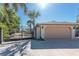 Property showcasing a wide driveway leading to a two-car garage and secure gated entry at 4438 Meager Cir, Port Charlotte, FL 33948