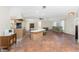 Open concept great room with tile floors, island, and a ceiling fan, creating an inviting and versatile living space at 4438 Meager Cir, Port Charlotte, FL 33948