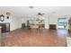 Spacious open-concept living area with tile flooring, offering easy access to the kitchen and outdoor space with water view at 4438 Meager Cir, Port Charlotte, FL 33948