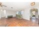 Bright living room features tile flooring, decorative cabinet and an open archway to front door, exuding warmth at 4438 Meager Cir, Port Charlotte, FL 33948