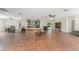 Open floor plan with terracotta floors connecting the kitchen, dining, and living areas at 4438 Meager Cir, Port Charlotte, FL 33948