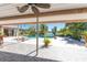 View of the pool and waterfront from an outdoor seating area with a ceiling fan for those bright sunny days at 4438 Meager Cir, Port Charlotte, FL 33948