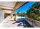 Covered patio, poolside bar, and lush tropical landscaping in this outdoor pool area, creating an inviting space to relax at 4438 Meager Cir, Port Charlotte, FL 33948