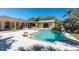 Backyard pool with access to the house bar and outdoor lounge on a bright day with palm trees and lush greenery at 4438 Meager Cir, Port Charlotte, FL 33948