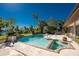 Backyard pool with spa, brick trim, tropical landscaping, lawn, and waterfront views on a bright sunny day at 4438 Meager Cir, Port Charlotte, FL 33948