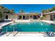 Backyard pool with brick trim and lush green landscaping on a bright sunny day in this outdoor backyard retreat at 4438 Meager Cir, Port Charlotte, FL 33948